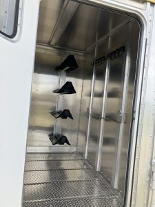 24' x 7' Lariat Stock Combo Trailer. Tandem 7,000 lbs Torsion Axles. ST235/85 R16(M) 14 Ply Tires on 16 X 6 Steel Rims Locking Tack Room with Four Removable Saddle Racks, Bridle Hooks, and Blanket Bar. One Fixed Divide Gate. 36" Roadside Door. Six Inside Tie Loops. Four Outside Tie Loops Roadside.