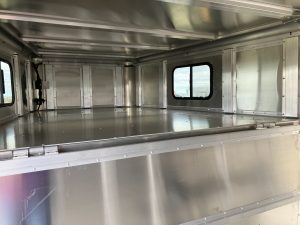 24' x 7' Lariat Stock Combo Trailer. Tandem 7,000 lbs Torsion Axles. ST235/85 R16(M) 14 Ply Tires on 16 X 6 Steel Rims Locking Tack Room with Four Removable Saddle Racks, Bridle Hooks, and Blanket Bar. One Fixed Divide Gate. 36" Roadside Door. Six Inside Tie Loops. Four Outside Tie Loops Roadside.